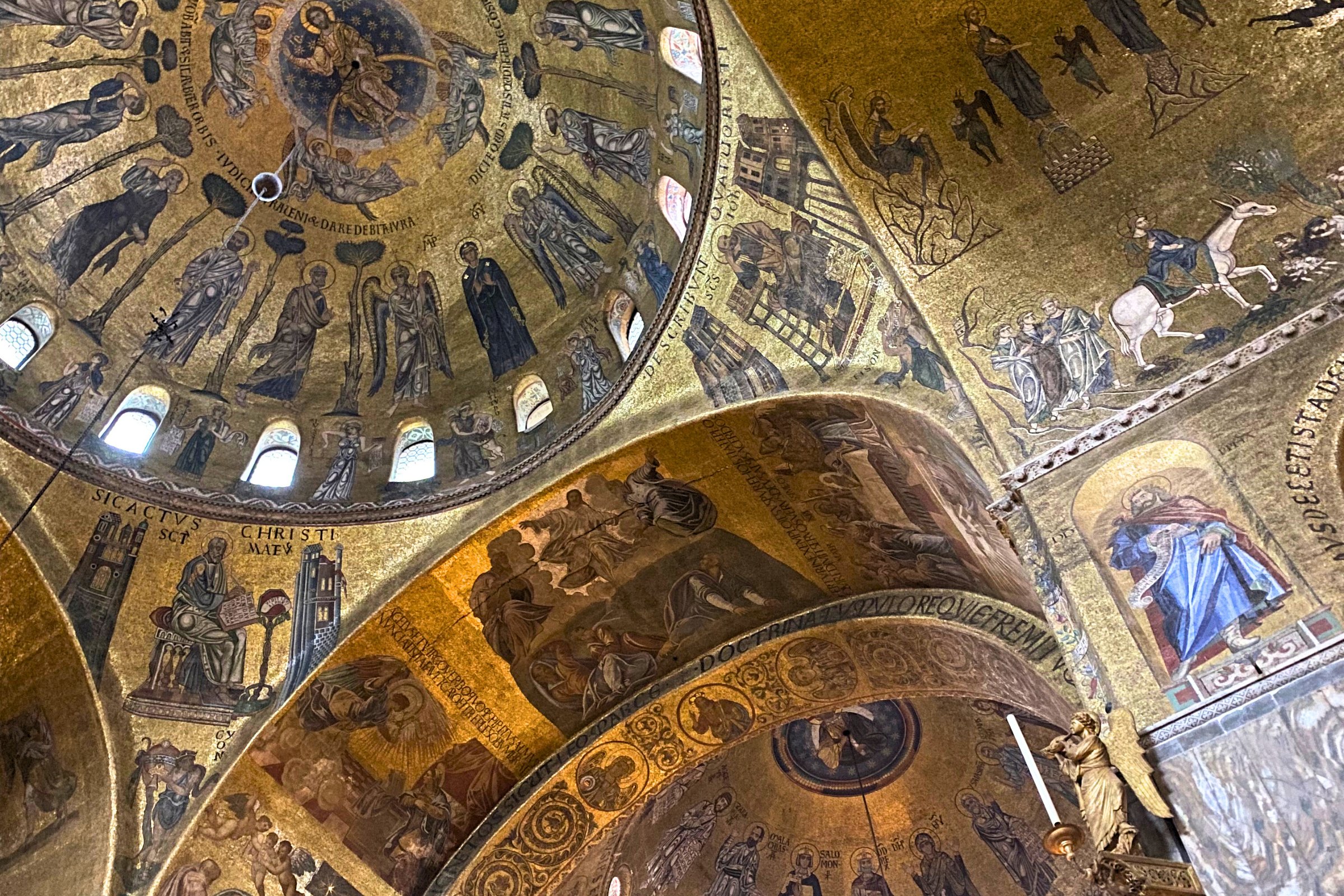Golden mosaics of saints and biblical scenes decorate the domes and arches of St. Mark’s Basilica.